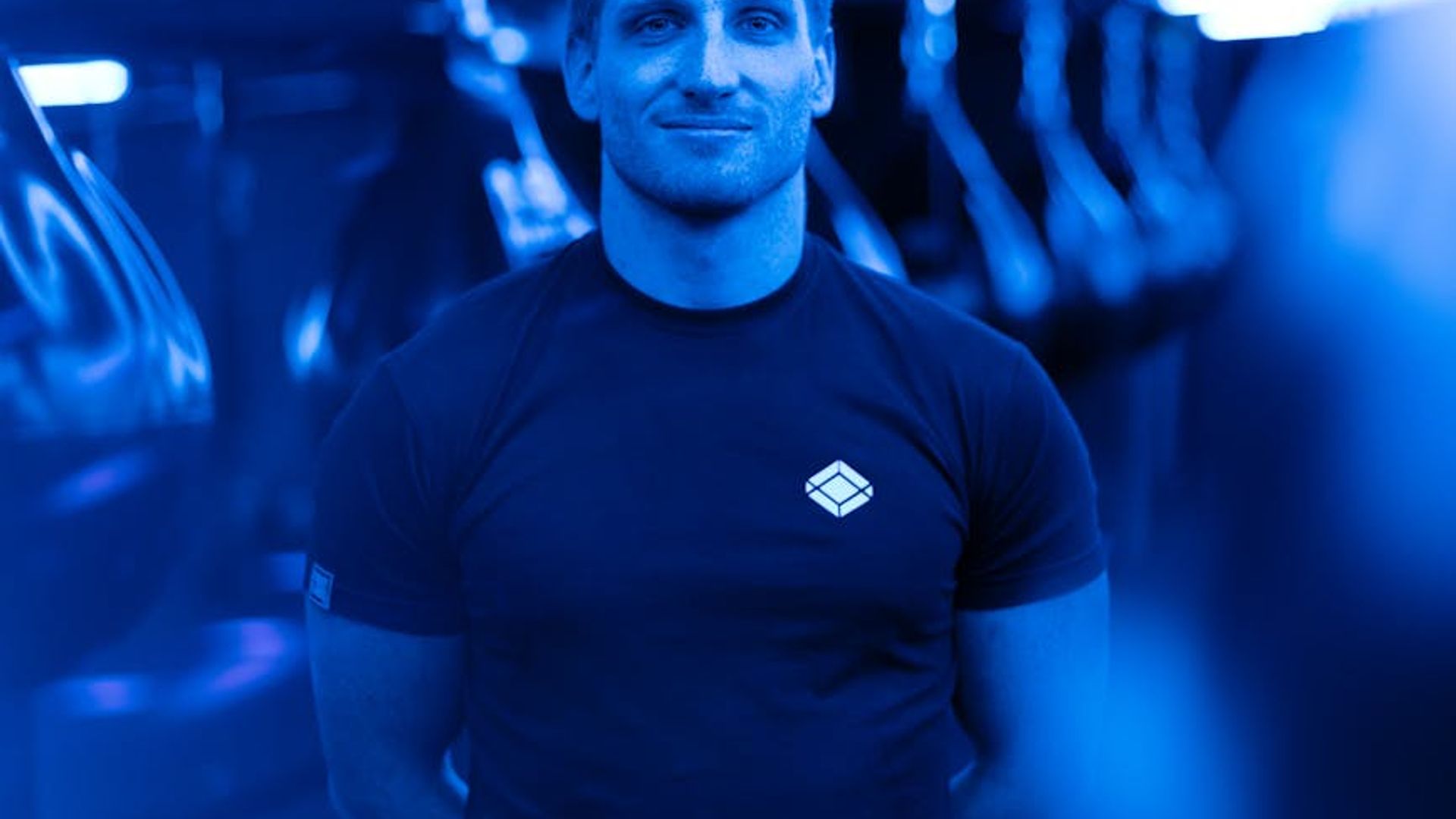 Strong man training in a dark modern gym with neon lights